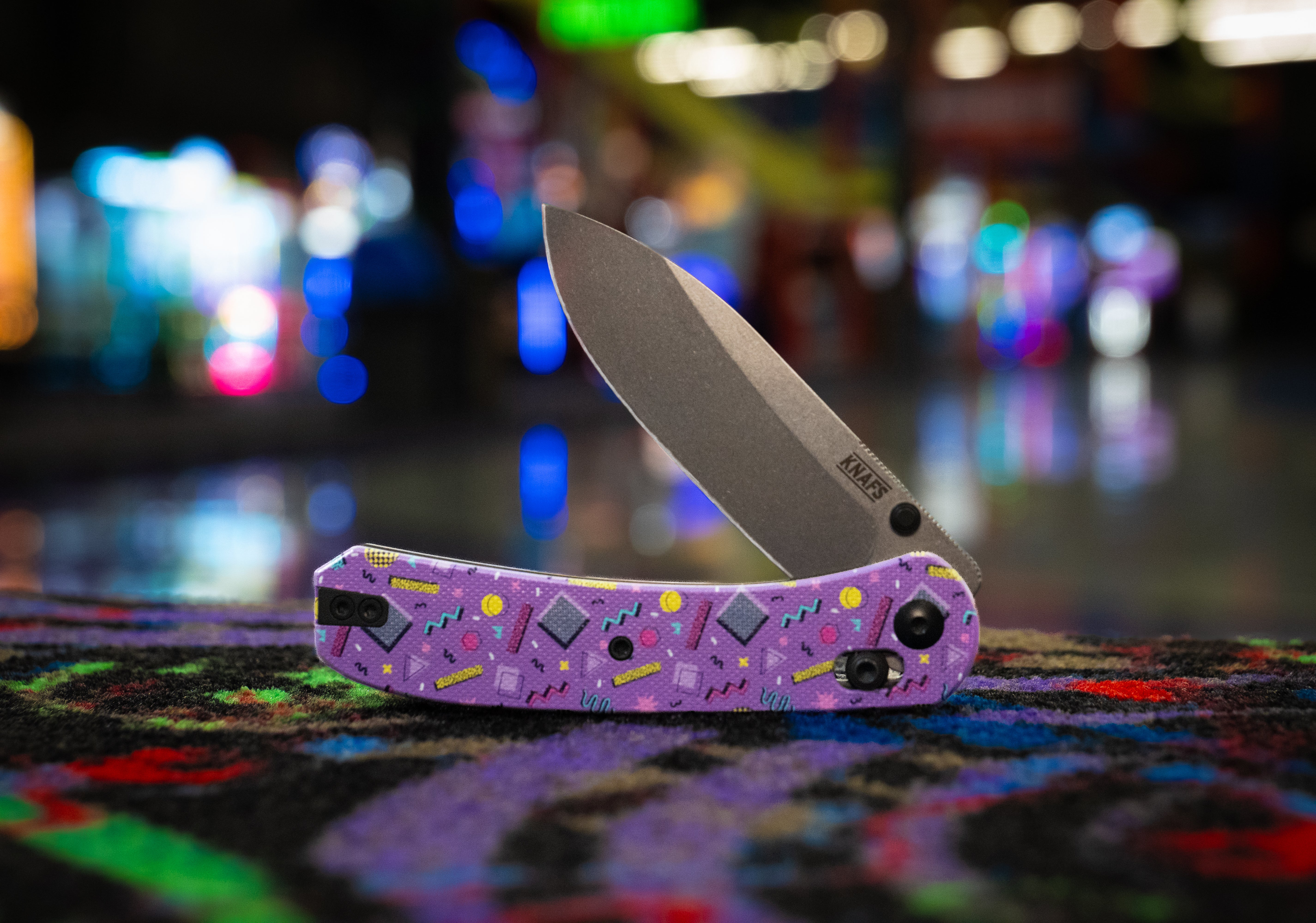 a folding knife with a purple handle