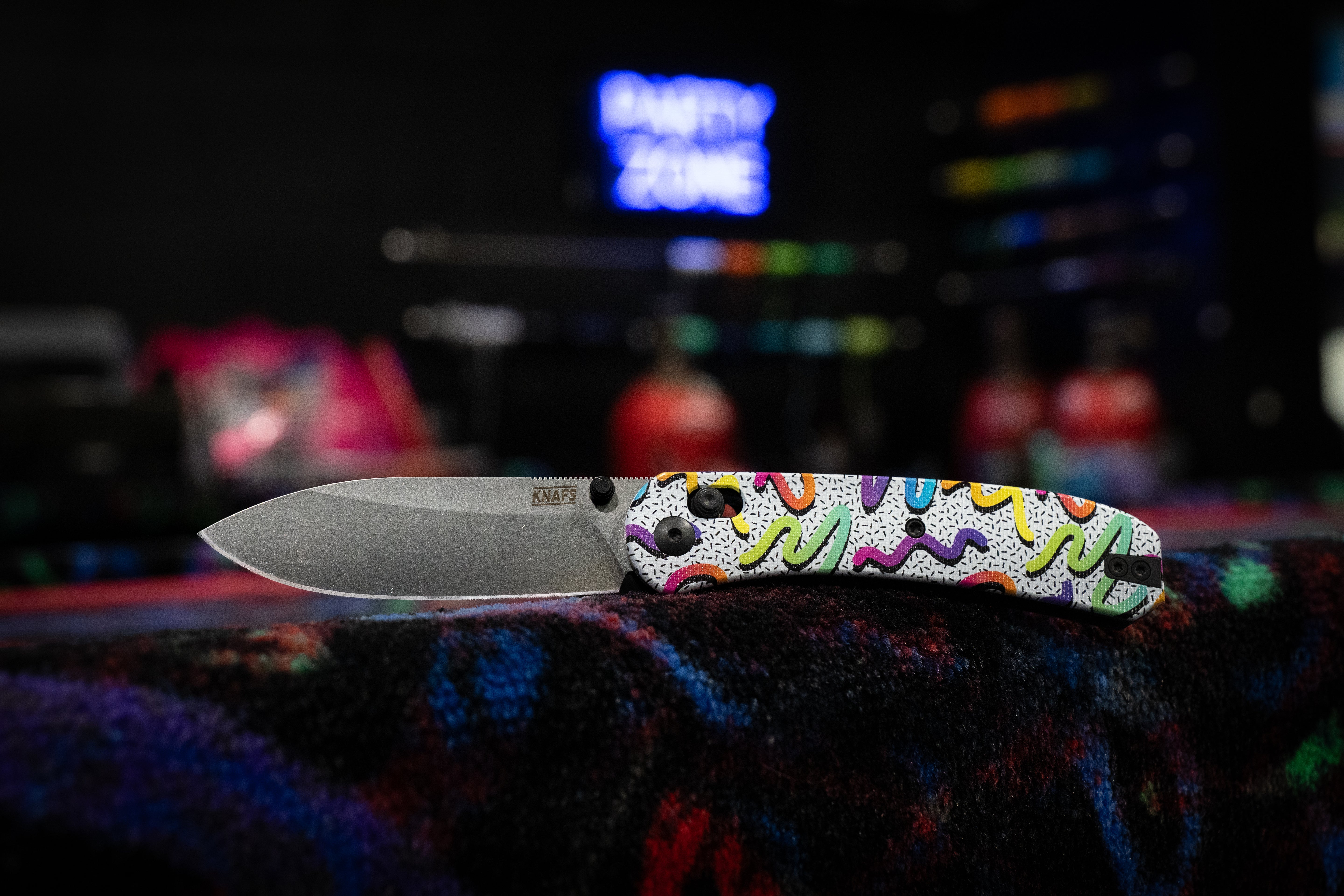 a folding knife with neon colored decoration