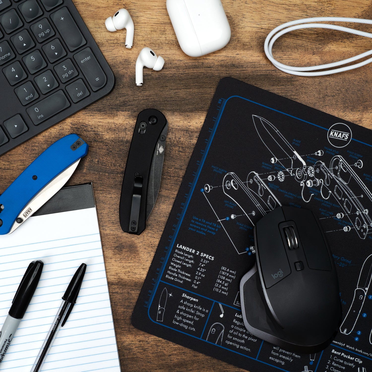Shop Mat / Mouse Pad - Lander 2 - Top View layed in the table with the knife