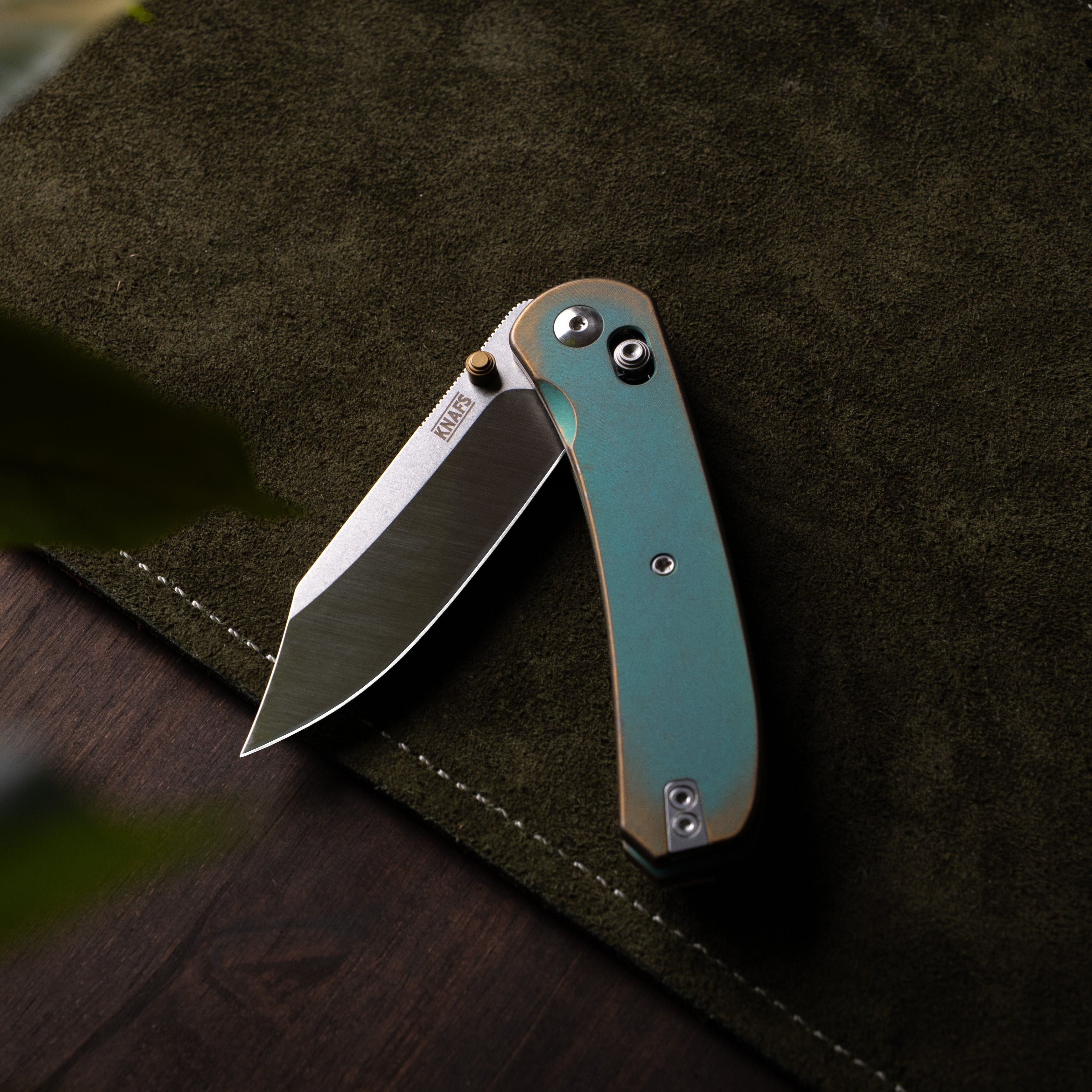 Folding knife on a dark surface 